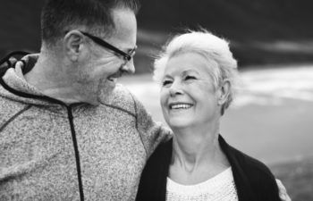 elderly couple smiling at each other