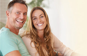 young couple smile together showing off their straight teeth