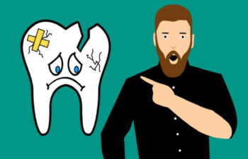 cartoon man points to a frowning, cracked and broken tooth that needs to be extracted